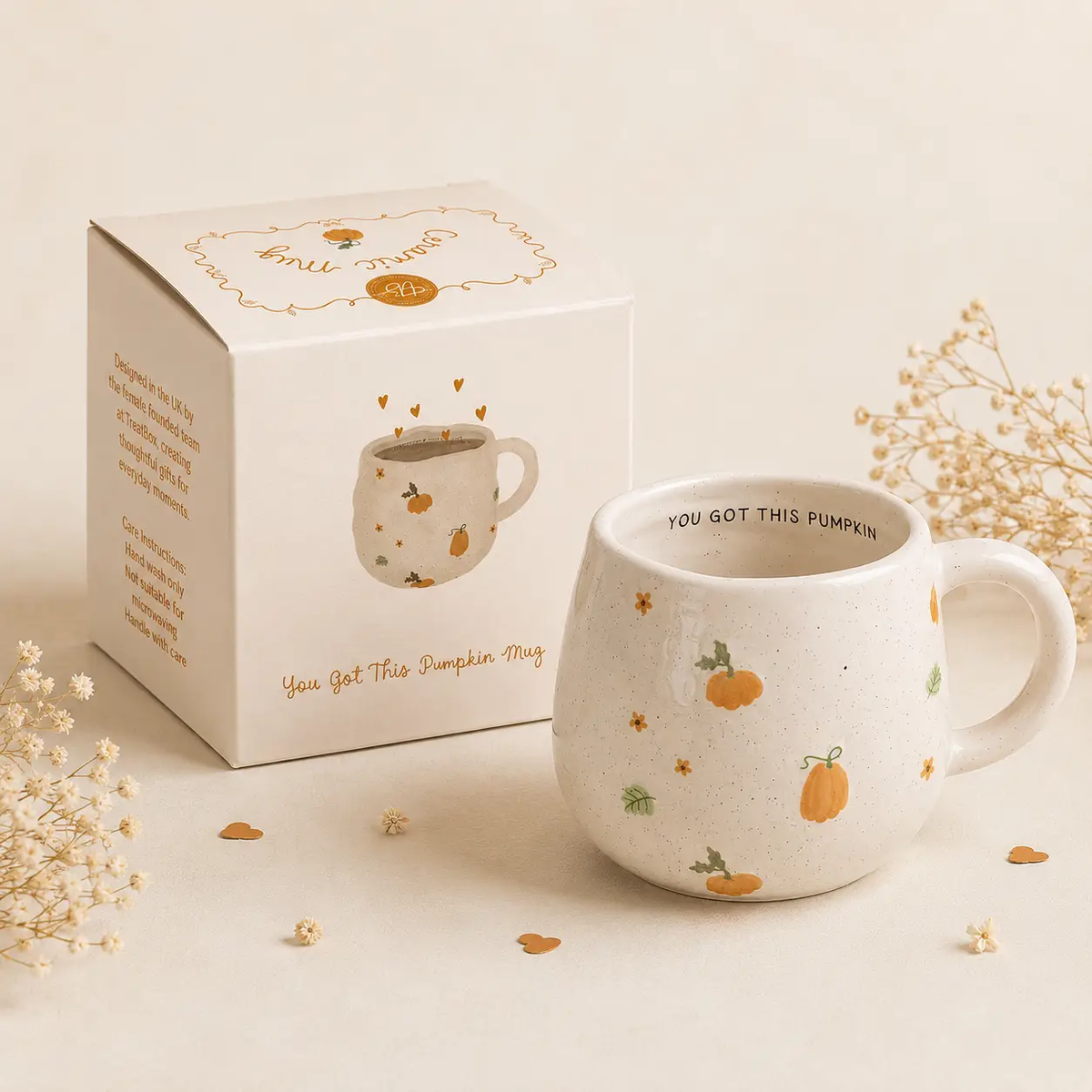 Cream speckled ceramic mug with orange pumpkins, green leaves and 'You Got This Pumpkin' lettering inside the rim, shown beside its matching gift box.